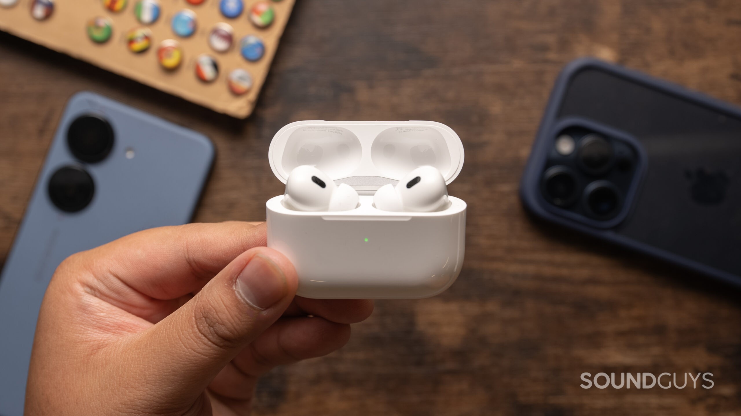 AirPods-Pro-2nd-Generation-USB-C-charging-case-open A hand holds the AirPods Pro (2nd generation).