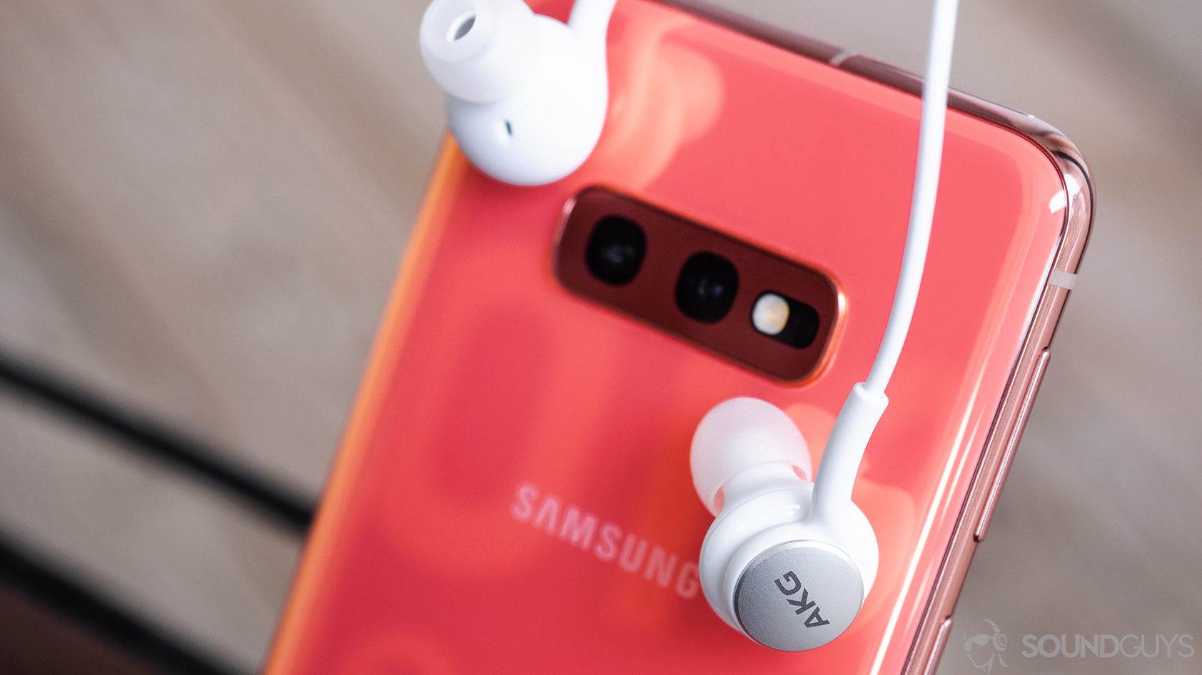 AKG_Samsung S10e-1 The AKG Samsung Galaxy S10e earbuds leaning against the rear of the phone.