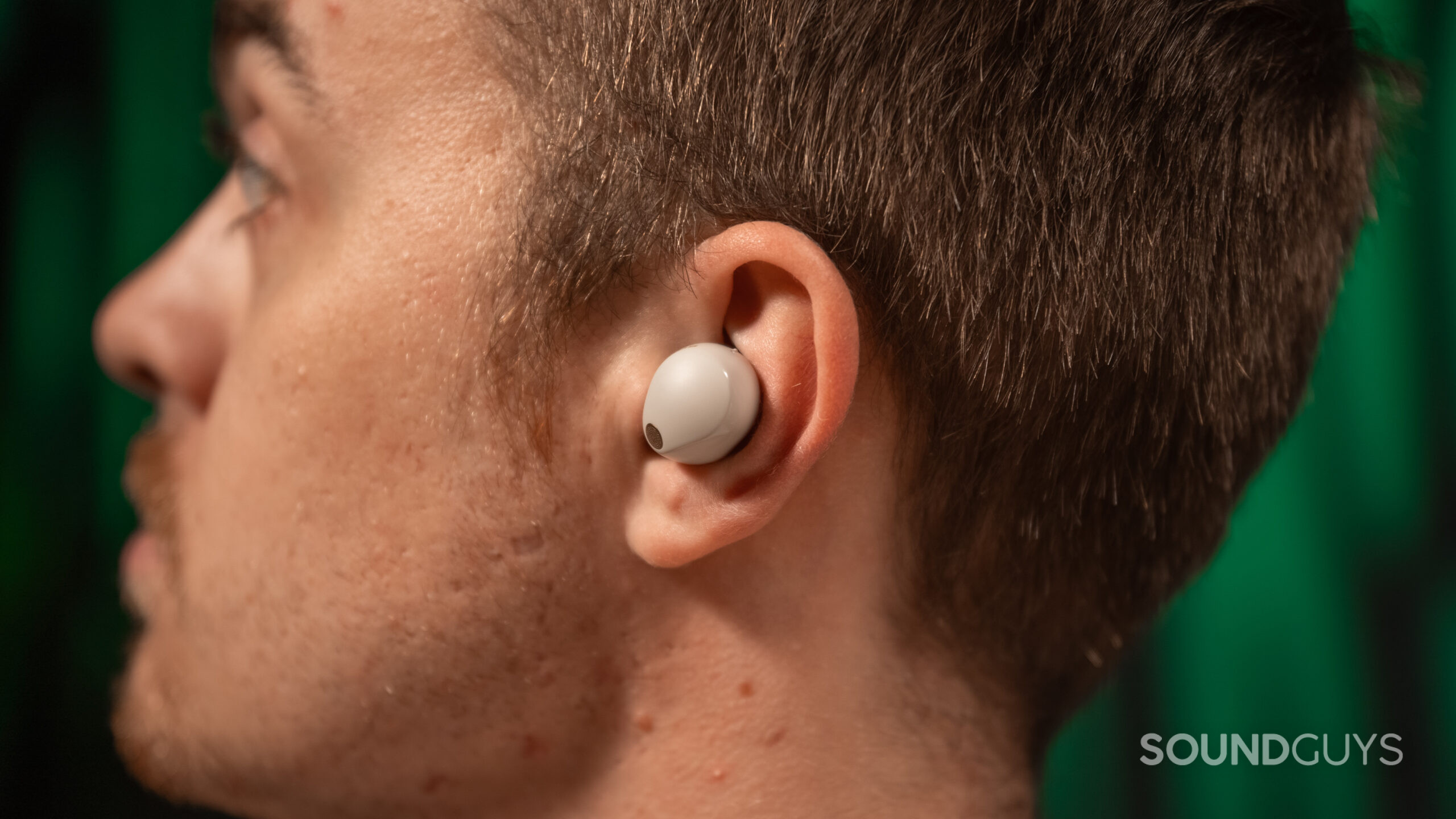 Close up of Sony WF-1000XM5 inside man's ear Close up of a man wearing the left earbud of the Sony WF-1000XM5