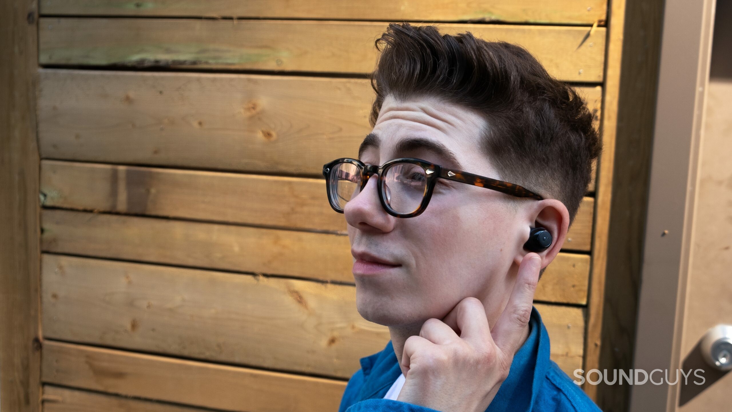 Anker Soundcore life A1 man wears A bemused man wears the Anker Soundcore Life A1 earbud outside.