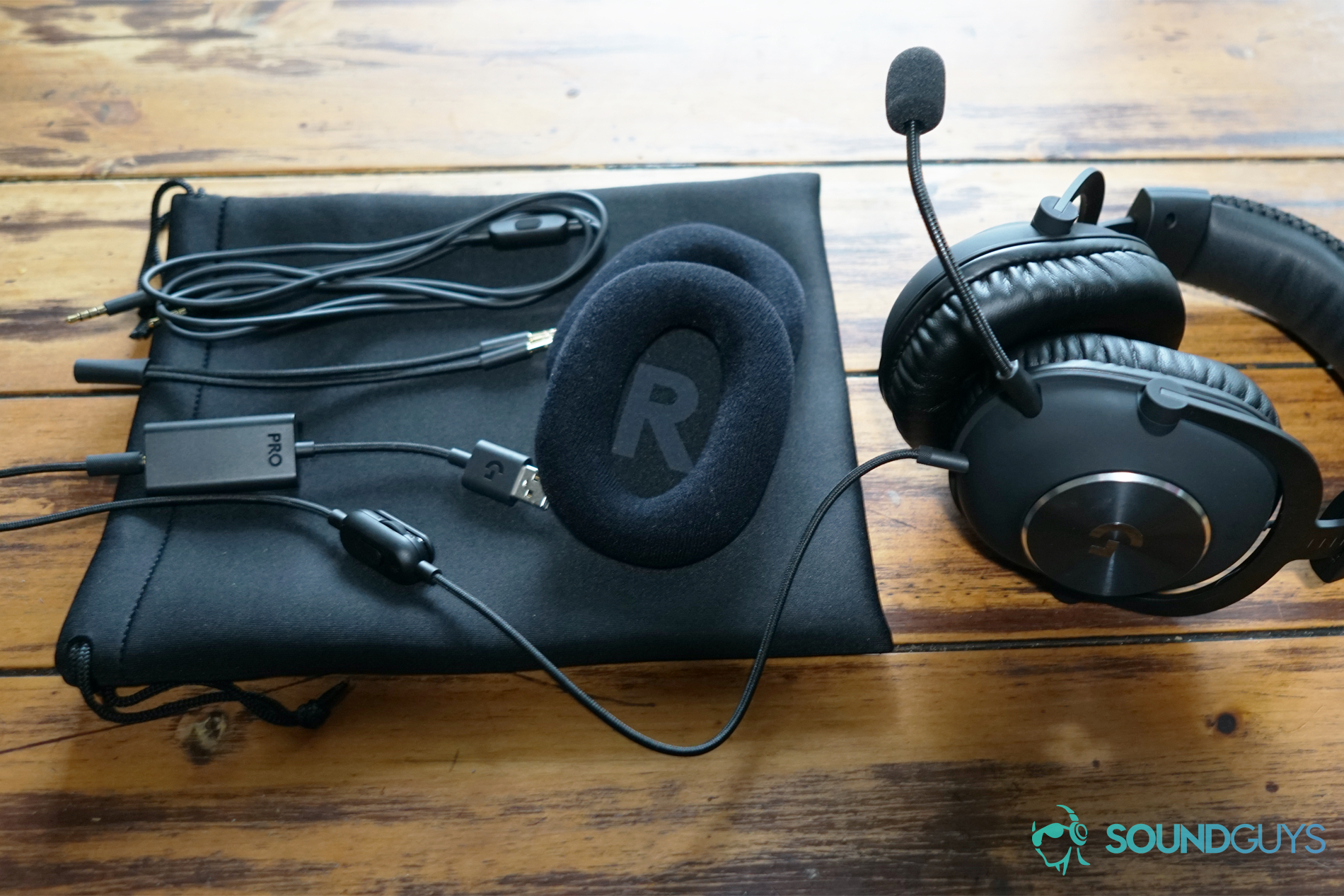 Logitech G Pro X OOB shot The Logitech G Pro X sits on a table next too all the different attachments it comes with.