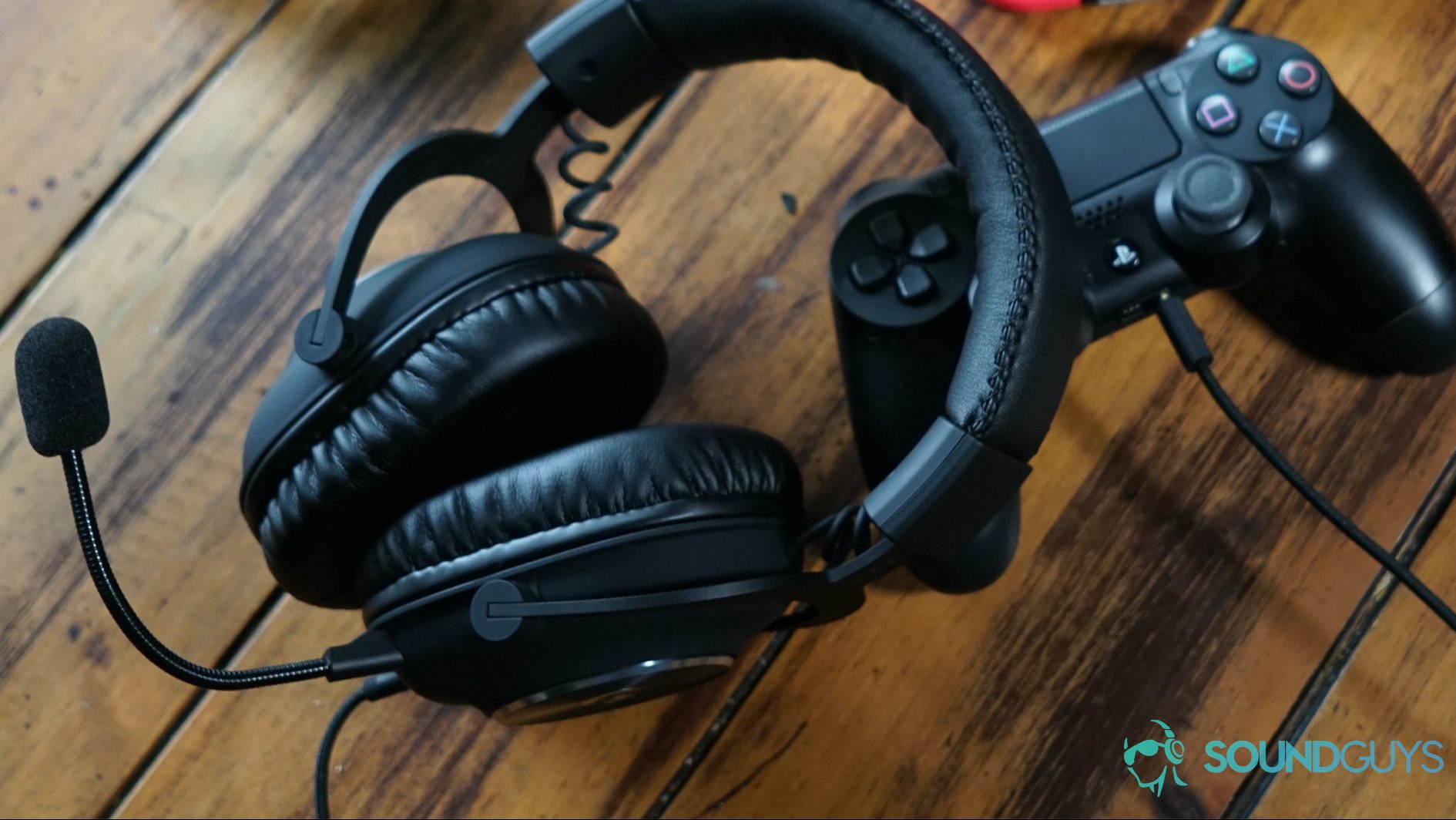 Logitech G Pro X top shot The Logitech G Pro X lying on a wooden table next to controllers for the Playstation 4 and Xbox One, as well as a Nintendo Switch Console