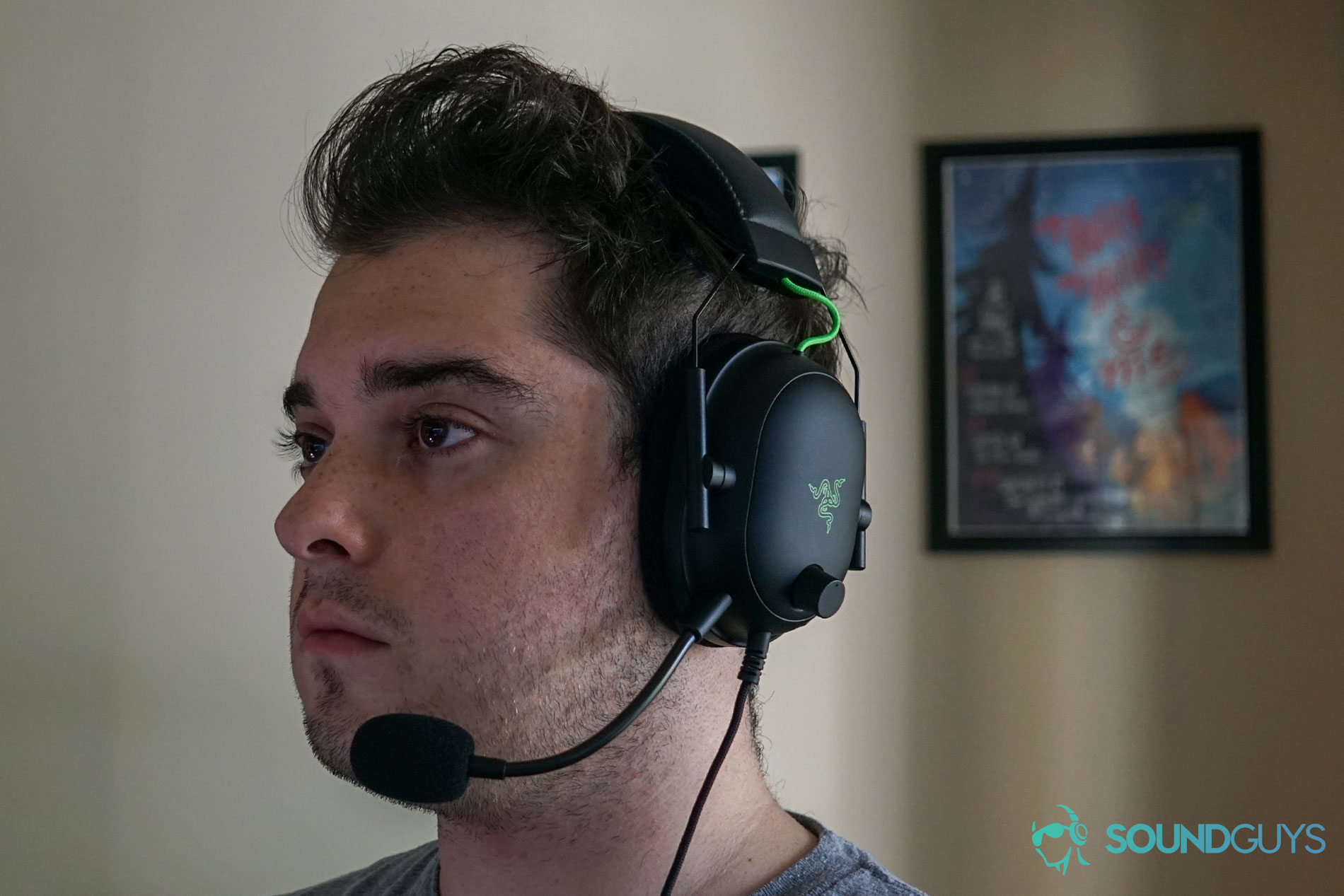 Razer BlackShark V2 gaming headset man wears A man wears the Razer BlackShark V2 gaming headset while sitting at a PC