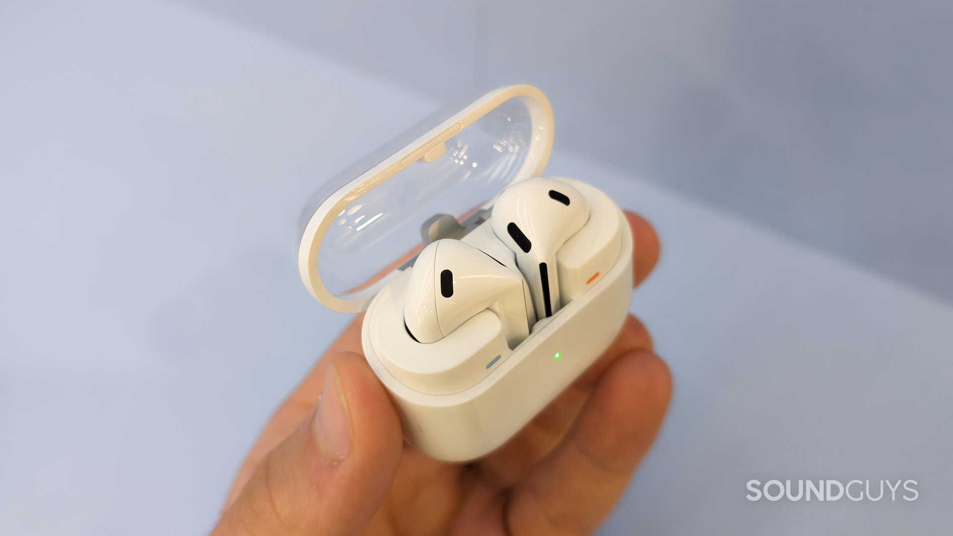 Samsung Galaxy Buds 3 Case Open Top Down with Earbuds Inside A hand holds the Samsung Galaxy Buds 3 earbuds inside their case.