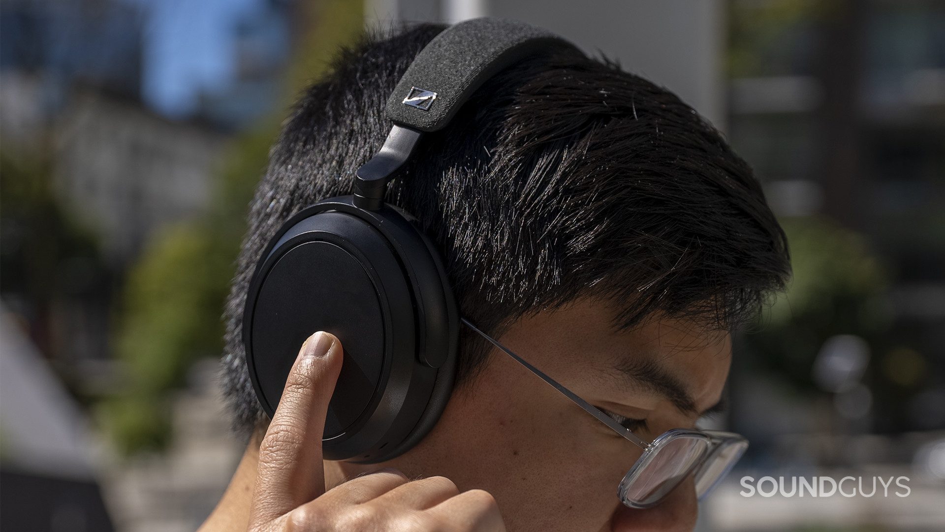 sennheiser-momentum-4-wireless-control A person uses the capacitive touch controls to control media playback.