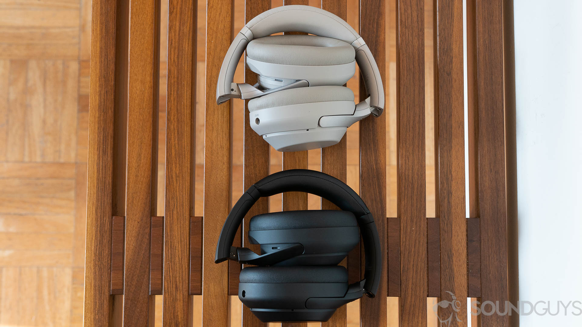 Sony WH-1000XM4 (3 of 4) An aerial picture of the Sony WH-1000XM3 and Sony WH-1000XM4 lay folded up on a wooden bench.